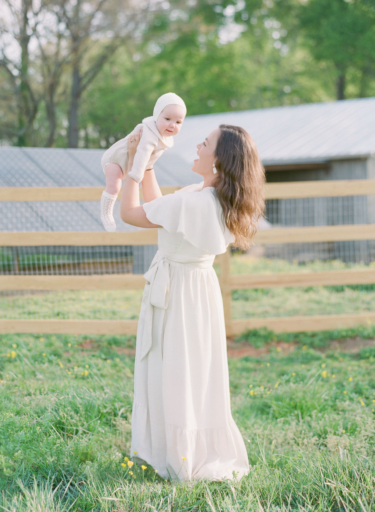 Kent-Avenue-Photography-Charlotte-Newborn-Photographers-On-Film-Mom-Holding-Baby-in-Air
