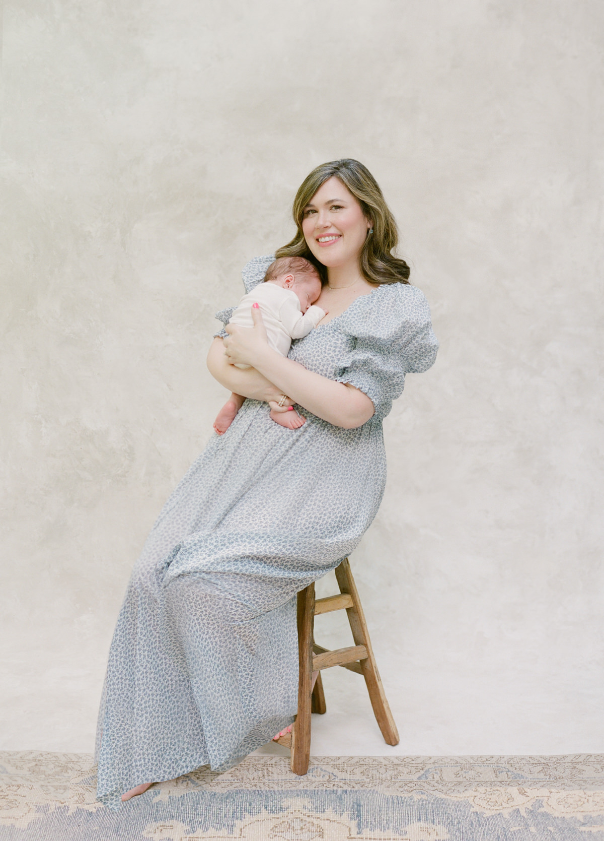 Charlotte Lifestyle Photography On Film - Mom sitting on a stool holding baby - Kent Avenue Photography