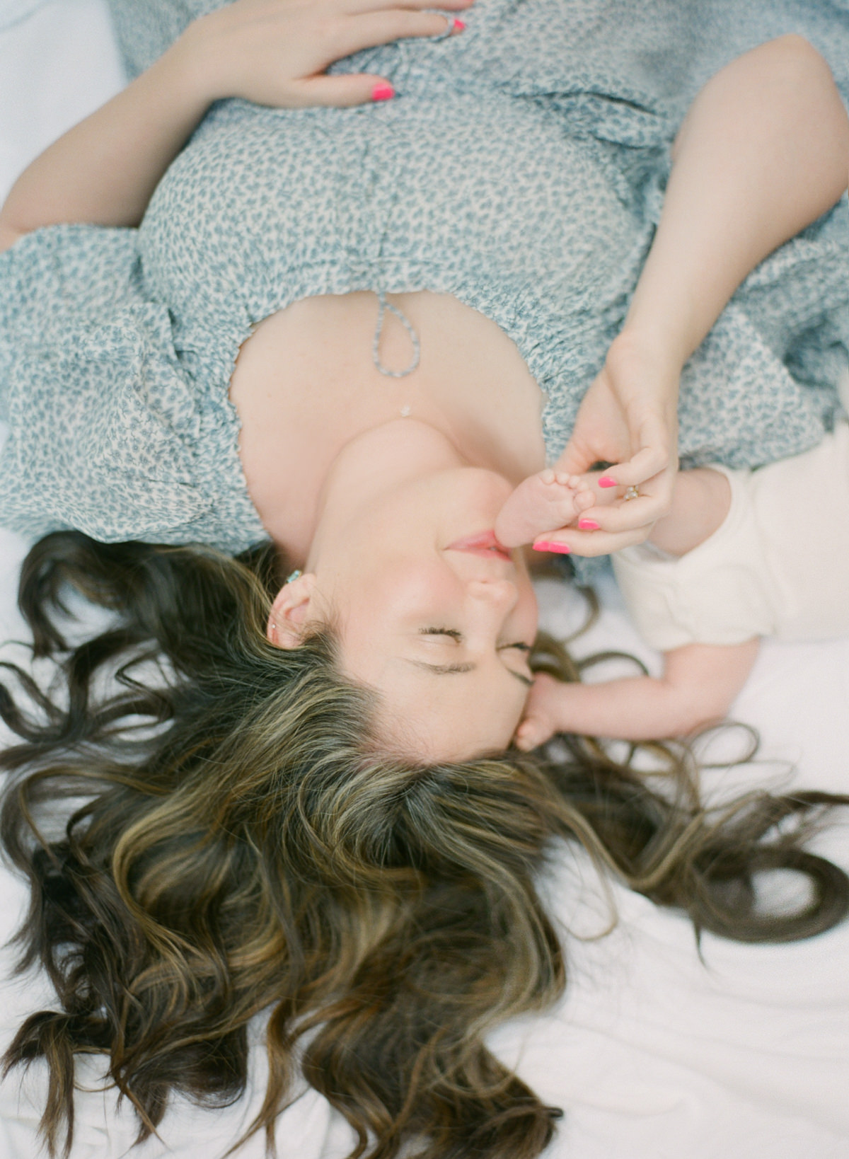 Charlotte Newborn Photographers - Mom kissing baby toes - Kent Avenue Photography