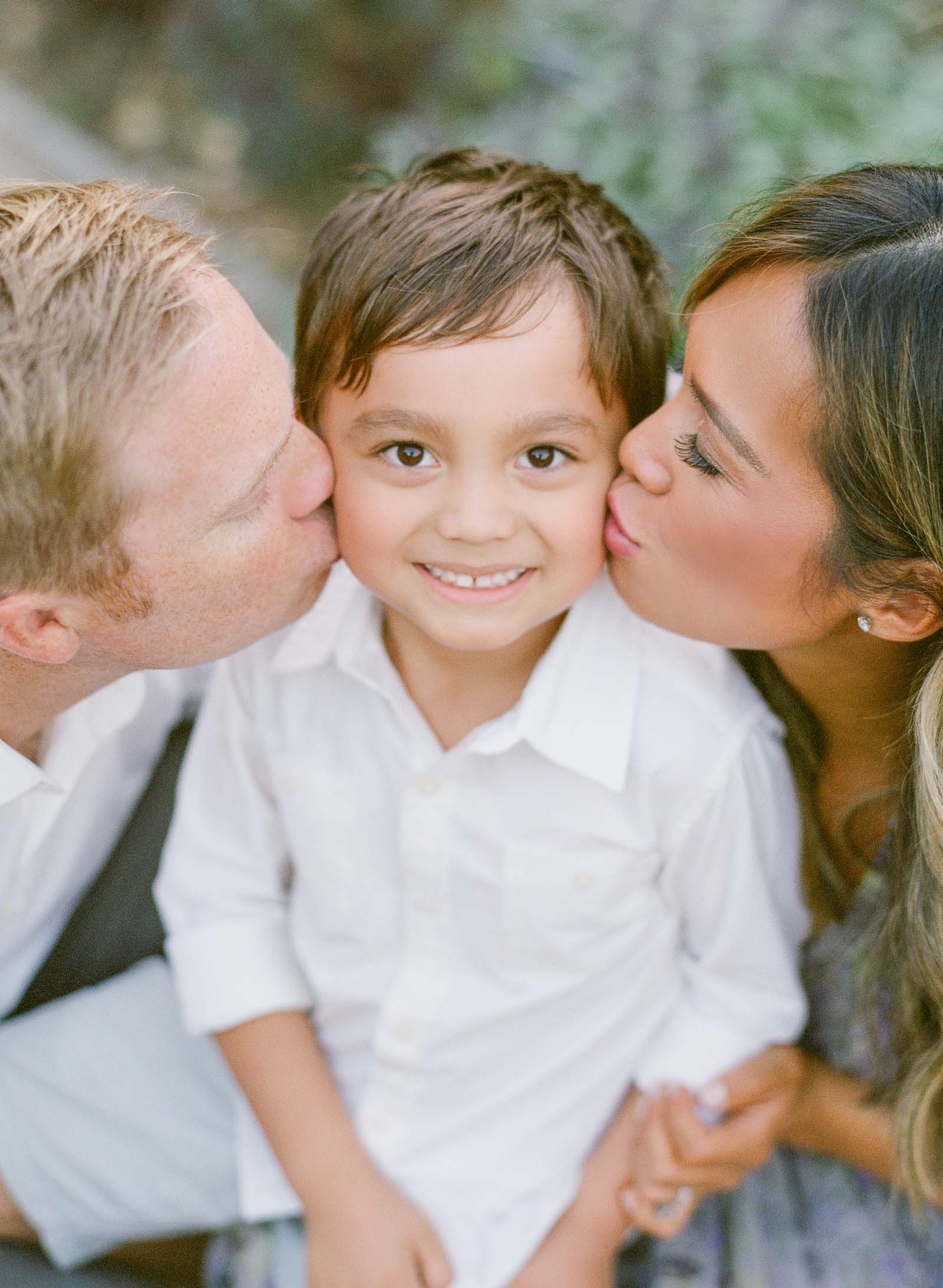 Mom and Dad kissing son - Light and airy family photography - San Francisco Bay Area Family Photography on Film - Family on Film - California Family Session - Mom and Dad looking at Children - Kent Avenue Photography - www.kentavenuephotography.com