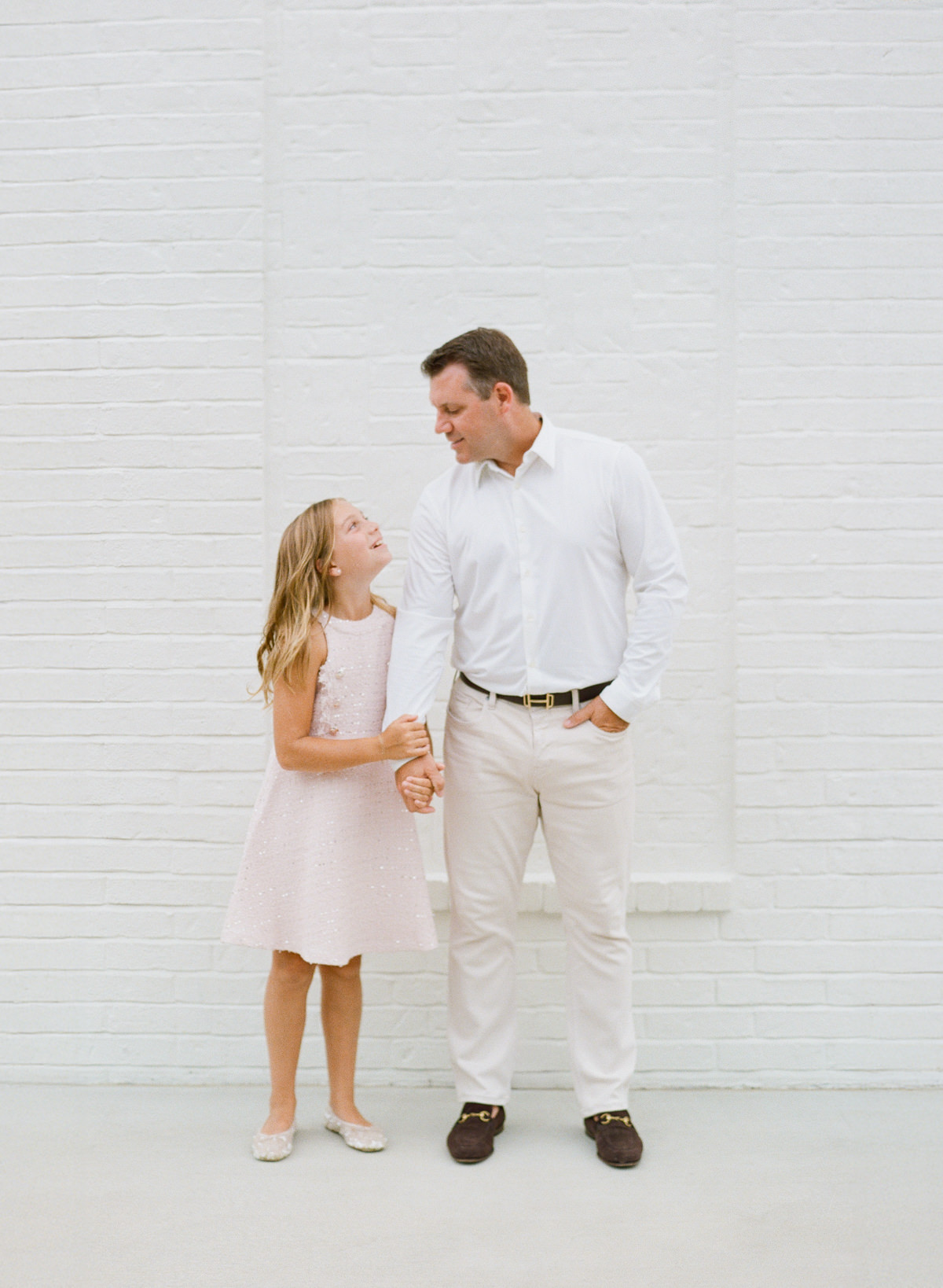 Dad and daughter sharing a candid moment during a Charlotte lifestyle family photography session