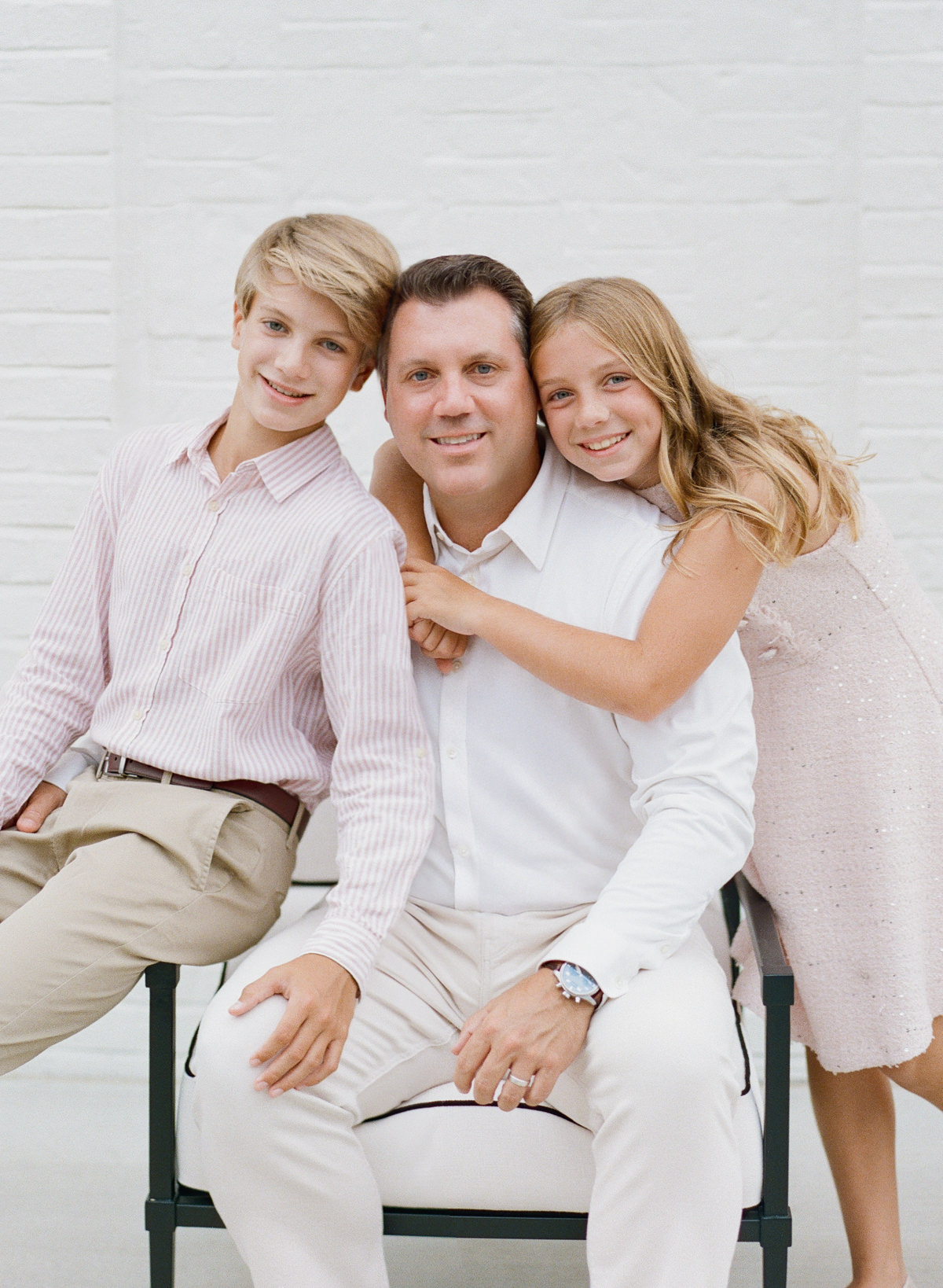 Father and children laughing together during a Charlotte family portrait session on film