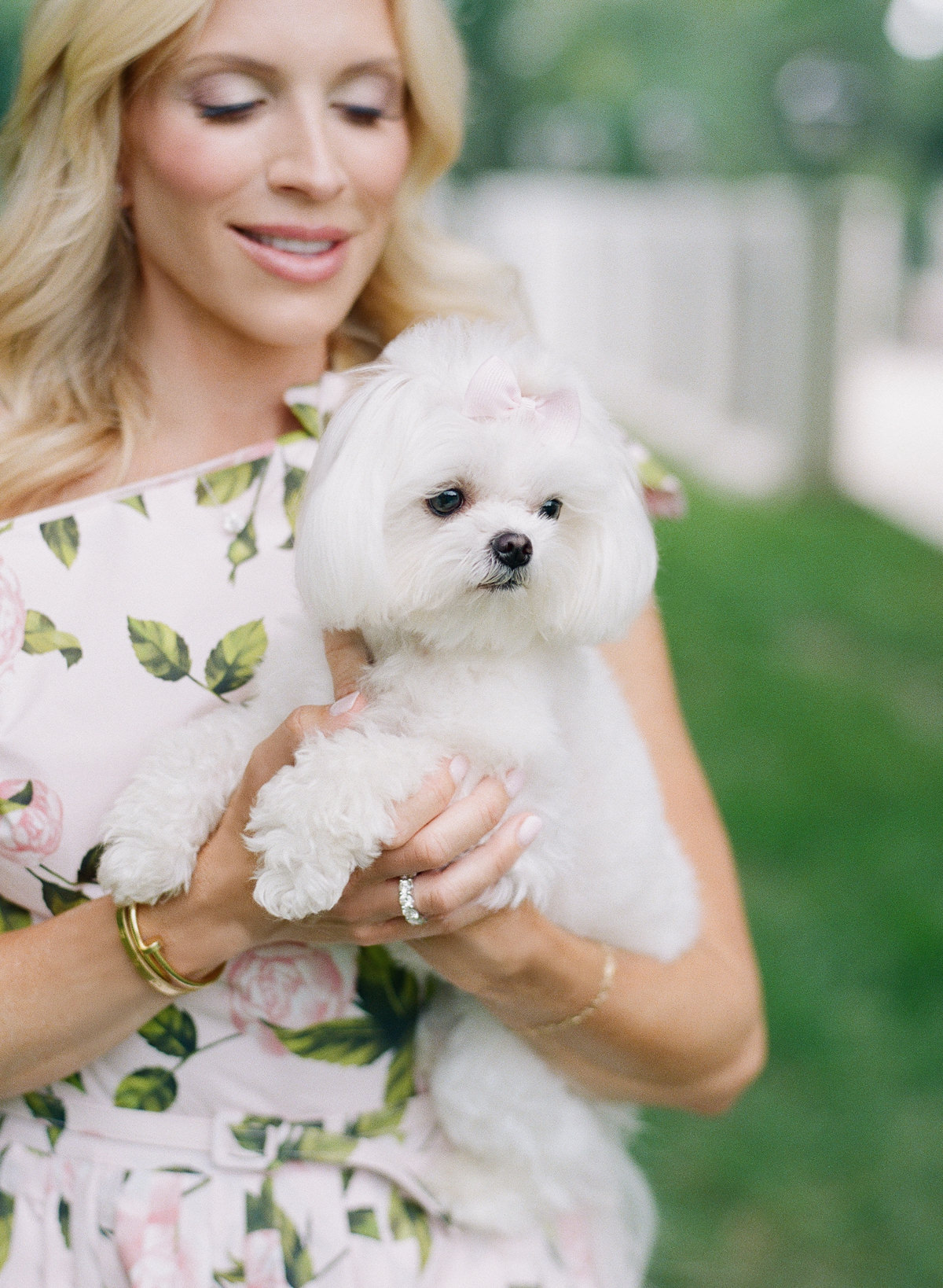 Mother smiling naturally in a candid Charlotte film photography session with her puppy