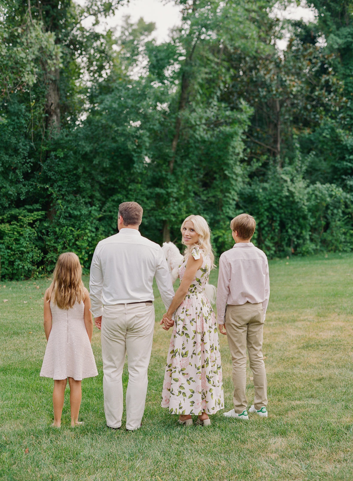 Family of four enjoying a relaxed outdoor portrait session in Charlotte, photographed on film by Kent Avenue Photography